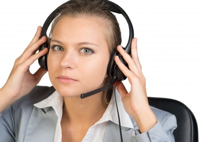 Businesswoman in headset, looking at camera